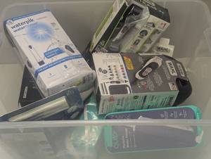 lot 18 image: Mixed Bin of Open Electric Shavers and Water Picks