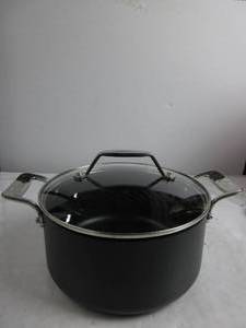 lot 2 image: All-Clad Essentials Nonstick Cookware (4 Quart Stock Pot with Glass Lid) HAS WATER MARKS, LID IS A BIT WOBBLY, USED