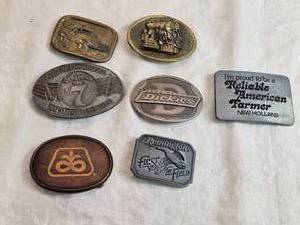 lot 313 image: Belt Buckles from brands like Remington, Dickies, and New Holland