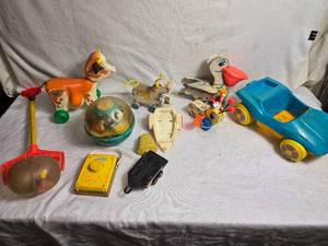 lot 46 image: Variety of Fischer Price and Other Toys Giraffe, Pelican, Bee, Pull Toys and More