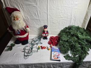 lot 232 image: Christmas Decor Collection Santa Dolls, Ornaments, Garland & Sing-Along VHS