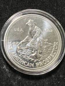 lot 18 image: 1 TROY OZ .999 FINE SILVER 1982 AMERICAN PROSPECTOR ROUND IN AIRTITE