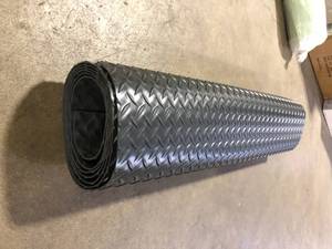 lot 20 image: Workforce Black 36 in. x 10 ft. Vinyl Diamond Plate Commercial Grade Matting Customer Returns See Pictures