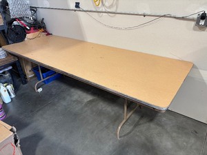 lot 1 image: 8 Foot Fold Up Table