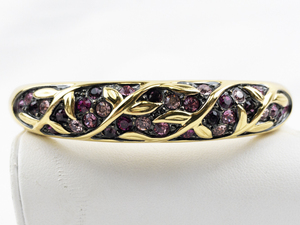 lot 447 image: Joan Rivers Pink Rhinestone Vine & Leaf Gold Tone Base Metal Hinged Bangle.