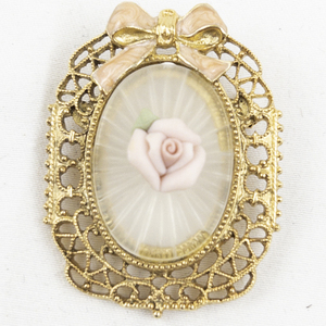 lot 392 image: Vintage Porcelain Rose With Enamel Pink Bow Gold Tone Base Metal Brooch .