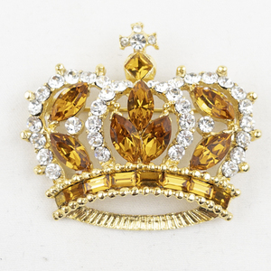 lot 394 image: Rhinestone Royal Crown Gold Tone Base Metal Brooch .