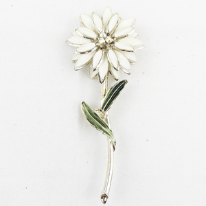 lot 399 image: White Enamel Flower gold Tone Base Metal Brooch .