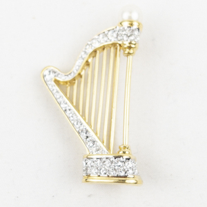 lot 402 image: Rhinestone Accented Harp Gold Tone Base Metal Brooch .
