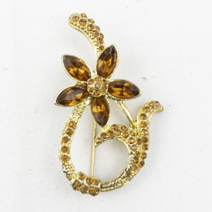 lot 409 image: Orange Rhinestone Swirl Flower Gold Tone Base Metal Brooch .