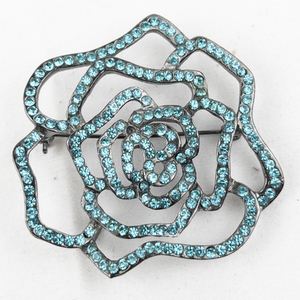 lot 411 image: Turquoise Rhinestone Flower Silver Tone Base Metal Brooch .