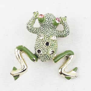 lot 416 image: Green Frog Jumper Gold Tone Base Metal Brooch . Missing Some Gem Stones