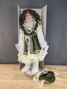 lot 105 image: New 1st Impressions Porcelain Doll with Green Dress and Bonnet B