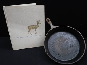 lot 22 image: LODGE CAST IRON SKILLET AND VINTAGE WILDLIFE BOOK