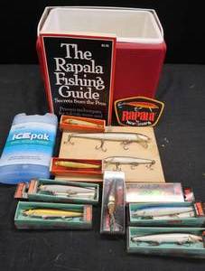 lot 61 image: LITTLE PLAYMATE COOLER FILLED WITH VINTAGE RAPALAS PLUS BONUS RAPALA BOOK AND PATCH