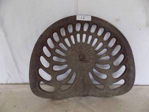 lot 12 image: Antique cast-iron tractor seat, Champion brand