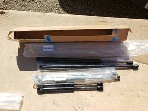 lot 144 image: NEW Gas Struts with SKUs 051064 and 051001 - 12 and 19 - 19 are for 1999 Jeep Grand Cherokee Rear Gate Shocks
