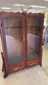 lot 285 image: Vintage Wooden Display Cabinet with Antler Accents and Glass Doors