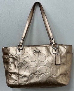 lot 22 image: Coach Gold Embossed Signature Gallery Leather Tote Bag