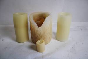 lot 7 image: Set of 4 Assorted Wax Candles with Decorative Design