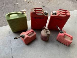 lot 630 image: Two Vintage 5-gallon Jerry Cans, a Justrite Safety Can, a Steri-Can, and 1.5 gallon Gas Cans