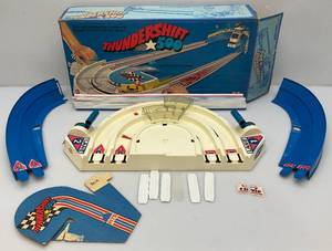 lot 105 image: 1974 Hot Wheels #7663 Thundershift 500  In Original Box (Missing Cars, Buttons, Flags, Stadium 2 Broken Tracks) Box Beat Up