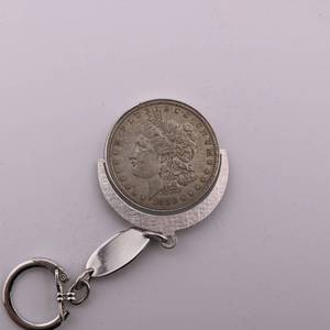 lot 50 image: 1880 Morgan Silver Dollar w Clip Attached