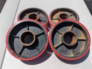 lot 90 image: Set of 4 - 6.25 Cast Iron Wheels - Heavy Duty Rollers - 1.75 Center Holes