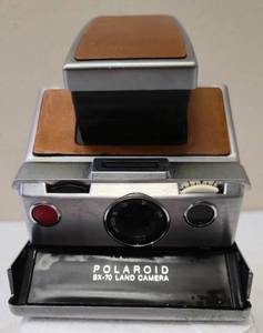 lot 56 image: Vintage from 1972-1981  Polaroid  Originals 4695 SX-70 Camera, Silver, Brown