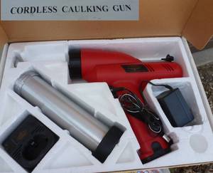 lot 63 image: Cordless caulking gun with 3 extra batteries and chargers