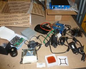 lot 100 image: Computer lot - small industrial PC, heat sinks, fan covers, network card, router, webcam, hard drive, speaker