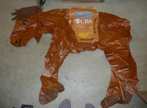 lot 82 image: Miller Beer inflatable moose (holds air) and Nixon mask for halloween