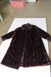 lot 54 image: Brown fur coat and black one is fur...