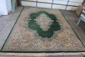 lot 40 image: Large area rug, done in greens and ...