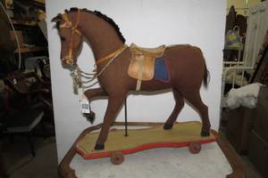 lot 91 image: Burlap horse on wood base with whee...