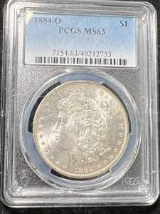lot 62 image: 1884-O US MORGAN SILVER DOLLAR PCGS MS63