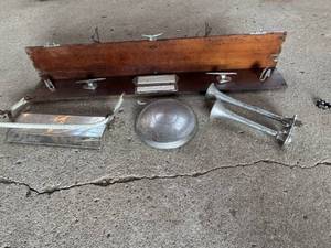 lot 143 image: Unique Coat Rack Air Horn, Hubcap and more