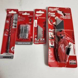 lot 73 image: Miscellaneous Milwaukee Items Open Packages Hammer Drill Bit 14, 4 Piece Screw Extractor, Utility Blades And 6in1 Utility Knife