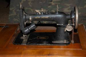 lot 163 image: Antique New Home Sewing Machine and Cabinet