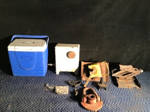 lot 68 image: Lot of Misc. - Cooler - Small Fish House Gas Heater - Lifting Cap - Jack Mounted on a Piece of Iron - Boat Plug and More