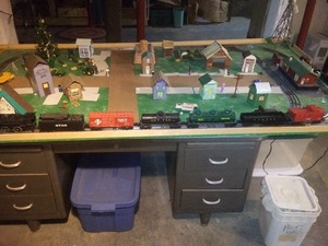 lot 1 image: Working Lionel Train Set on Tracks with Lionel Water Tower and Depot with Homemade Roads and Villages Mounted on a 4 x 8ft Sheet of Plywood