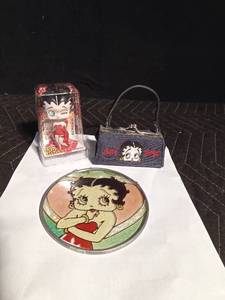 lot 217 image: 2007 betty Boop lip gloss and Betty Boop coin purse and Betty Boop sun catcher