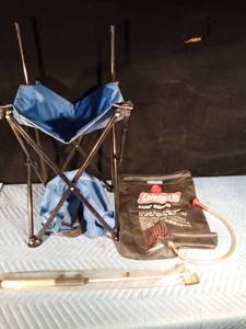 lot 135 image: Coleman portable camp shower, fishing stool with storage bag and a new ice fishing rod