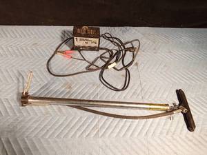 lot 132 image: Motorcycle battery charger and a hand tire pump
