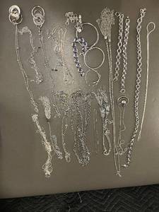 lot 98 image: Collection of Silver colored Jewelry with Chains, Bracelets, and Crystal Accents
