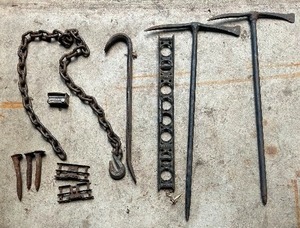 lot 260 image: Vintage Goodies including Railroad Spikes, Pick Axes, Heavy Duty Log Tow Chain, Millers Falls, 24 Cast Iron Level and More