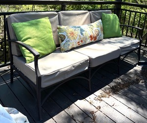 Outdoor Sofa with Tan Cushions and Decorative Pillows