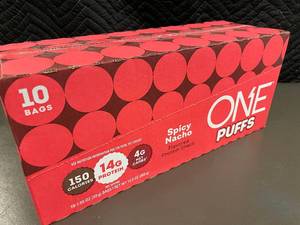 lot 63 image: CO 2 - Box of 10 Bags ONE Puffs Spicy Nacho Flavored Protein Snack
