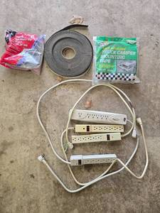 lot 139 image: Collection of Power Strips, Truck Camper Mounting Tape, and Foam Weather Strip - content quantities unverified