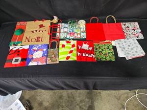 lot 100 image: Assorted Christmas Gift Bags, Tags, and Decorative Items